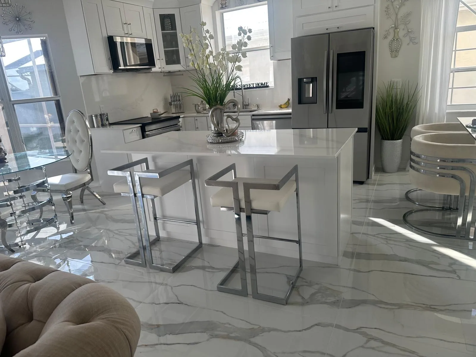 White kitchen with a quartz island and bar stools, kitchen remodel in Port St Lucie, FL