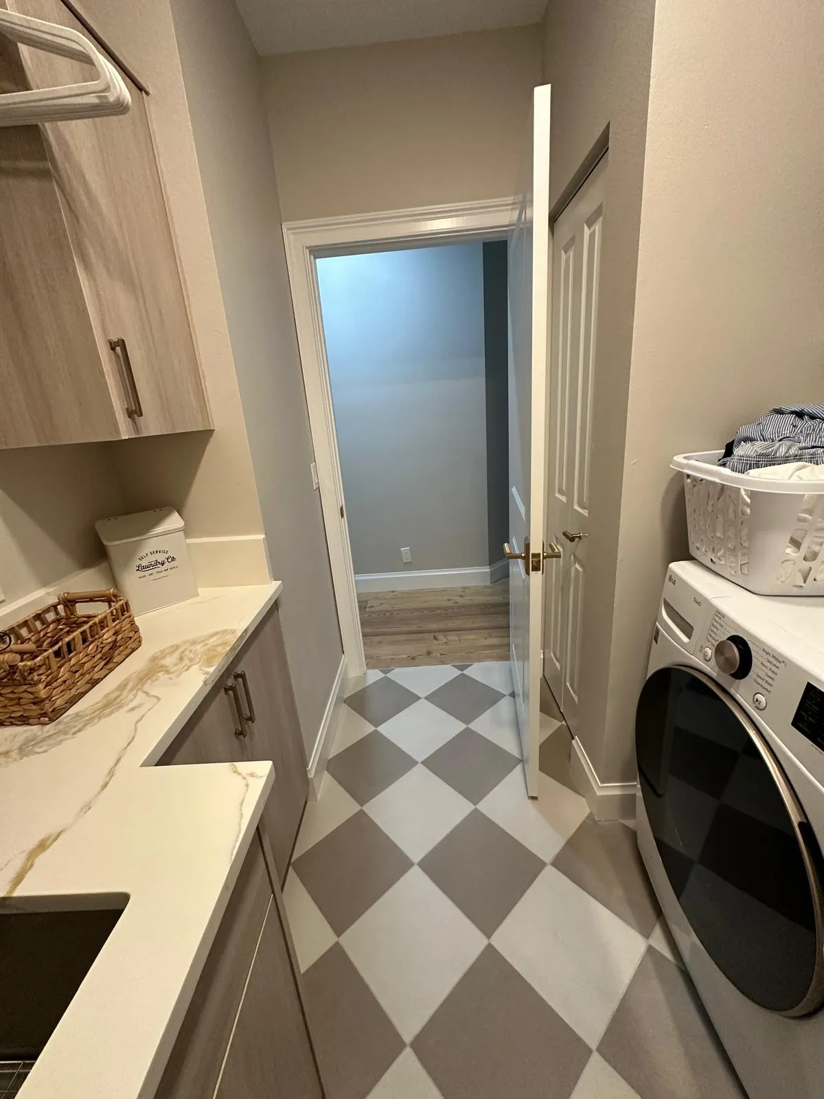 Laundry room with checkered tile floor and built-in cabinets, interior remodeling in Port St Lucie, FL