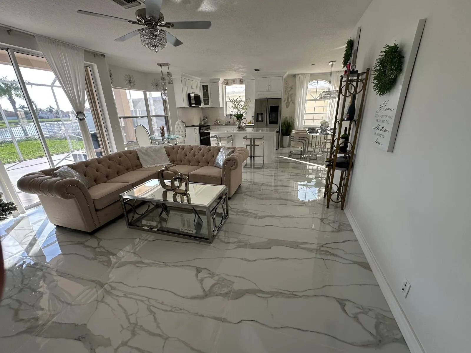 Living room with a continuous porcelain tile floor, home remodel in Port St Lucie, FL
